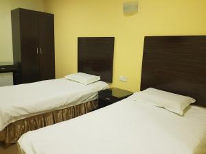 Postel nebo postele na pokoji v ubytování New City Hotel