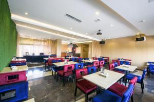 a restaurant with colorful chairs and tables and tablesktop at Foshan Taohuayuan Boutique Motel in Foshan