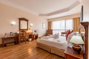 A bed or beds in a room at Hotel Pokhara Grande