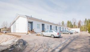 a group of cars parked in front of a house at Hämeentie Apartments in Järvenpää