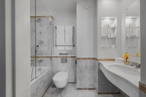 
a bathroom with a toilet, sink, and bathtub at Angleterre Hotel in Saint Petersburg
