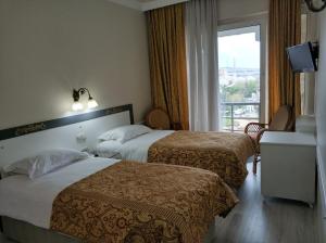 a hotel room with two beds and a window at Hali Hotel in Istanbul