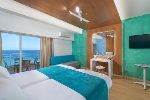 a hotel room with a bed and a view of the ocean at Arte hotel in Rhodes Town