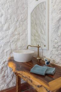 a bathroom with a white sink on a wooden table at Villa Didovi Dvori in Vrsine