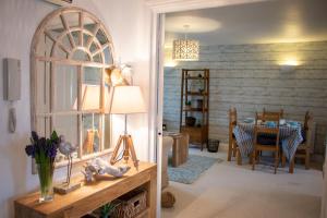 a living room with a table and a dining room at The Beach House Holiday Apartments in Eastbourne