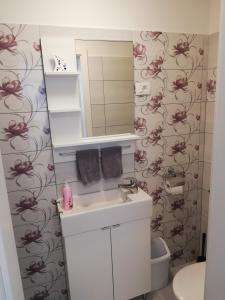 a bathroom with a sink and a mirror at PortoBello in Portorož