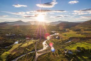 an aerial view of a valley with the sun setting at Húsafell holiday homes in Húsafell
