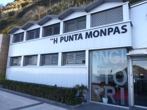 
a building with a sign on the front of it at Hotel Punta Monpas in San Sebastián

