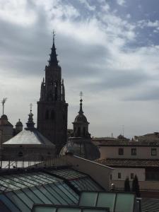 a view of a building with two towers and roofs at Ático del Rojas in Toledo