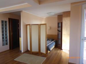 a room with a bed and a room with a closet at Kantal Apartamenty Hel in Hel