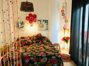 a bedroom with a bed with a colorful blanket at Antares in Altea
