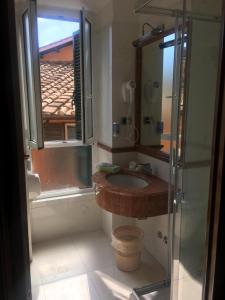 a bathroom with a sink and a shower at Hotel Hiberia in Rome