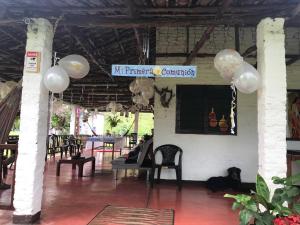 a party hall with balloons and a sign that reads my premier conference at Ginebra Glamping in Ginebra