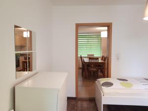 a room with a bed and a dining room at City-Apartment in Sinsheim