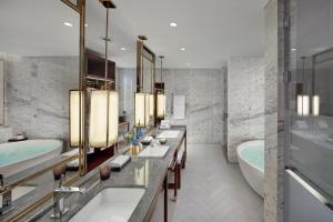 a bathroom with two sinks and a tub and a bath tub at Mandarin Oriental Wangfujing, Beijing in Beijing