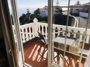 a balcony with a view of a white fence at Hotel Boomerang in Valverde