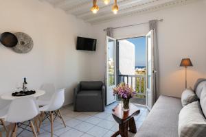 a living room with a couch and a table at Secret Garden Apartments in Mikonos