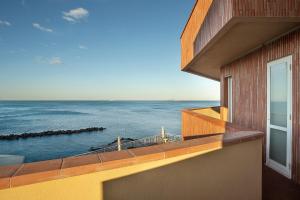 a view of the ocean from the balcony of a house at Hotel Rex in Livorno