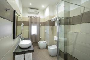 a bathroom with a toilet and a sink and a shower at Hotel Rex in Livorno