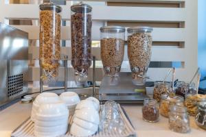 a counter with a bunch of containers of food at Hotel Rex in Livorno