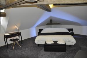 a bedroom with a bed and a dresser at Les Tonnelles in Bar-sur-Seine