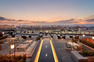 a rooftop restaurant with a view of the city at Mandarin Oriental Wangfujing, Beijing in Beijing