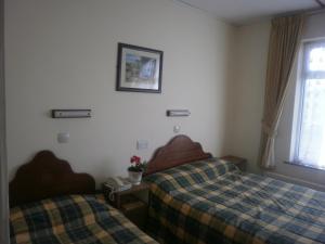 Postel nebo postele na pokoji v ubytování Sancta Maria Hotel