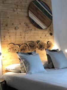 a bedroom with a large bed with a wooden wall at Terra di Sicilia Luxury Centro in Avola