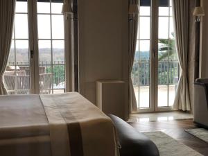 a hotel room with a bed and large windows at Kemer Country Hotel İstanbul in Istanbul