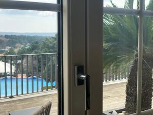 a sliding glass door with a view of a pool at Kemer Country Hotel İstanbul in Istanbul