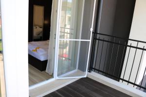 a sliding glass door leading to a bedroom at сем. Павлови in Obzor