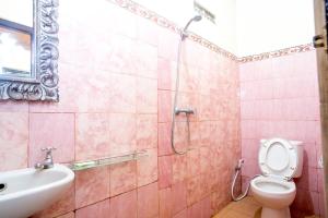 e bagno con servizi igienici, lavandino e doccia. di Shindu Home Stay ad Ubud