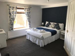 a bedroom with a bed and a window at The Chequers Inn in Darlington