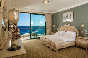 a bedroom with a bed and a large window at Royal Princess Hotel in Dubrovnik