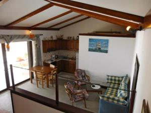 a kitchen and dining room with a table and chairs at Patras Roof apartment in Agios Georgios Pagon