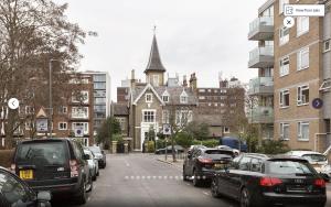 a street with cars parked on the side of the road at Putney 1 Bed Apartment by BaseToGo in London
