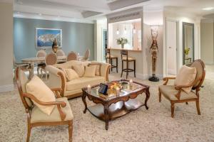 a living room with a couch and chairs and a table at Royal Princess Hotel in Dubrovnik