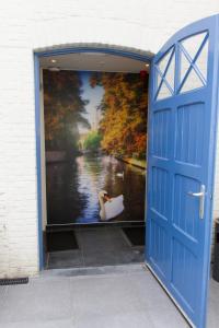 
a door that is open in front of a building at Golden Tree Hotel in Bruges
