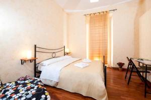 a bedroom with a bed and a table and a desk at Residenza Laterano in Rome