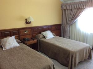 Postel nebo postele na pokoji v ubytování Hotel O Castelo