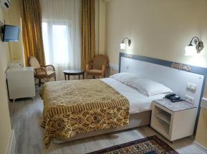 a hotel room with a large bed in a room at Hali Hotel in Istanbul