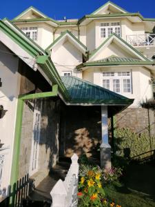 una casa con un toldo verde delante de ella en Melford Nuwaraeliya en Nuwara Eliya