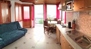 a kitchen and living room with a couch and a table at Guest House Julia in Senj