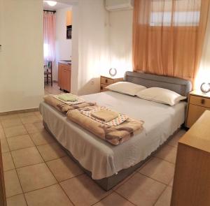a bedroom with a large bed in a room at Guest House Julia in Senj