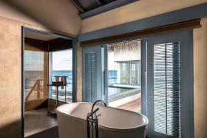 加弗阿利夫环礁Raffles Maldives Meradhoo的浴室里的浴缸，可欣赏海景