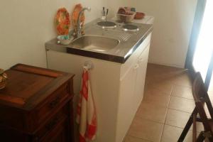 a kitchen with a sink and a counter top at A Kasuzza in Pantelleria