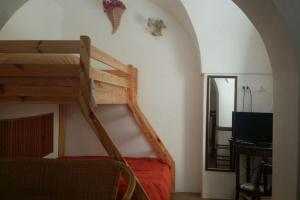 a bedroom with a bunk bed with a ladder at A Kasuzza in Pantelleria