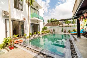 uma imagem de uma piscina numa casa em Sunny Riverside Homestay em Hoi An