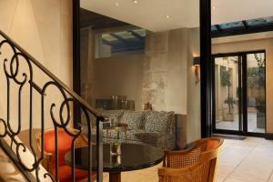 a living room with a table and a couch at Hôtel Saint Germain in Paris