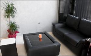 a living room with a couch and a coffee table at Hotel Leder in Kočani